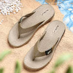 Front upper side image of A close up slight high angle shot of single color men's flip flop sandal by flite. The sandal has a textured, slightly bumpy footbed and a thick durable looking sole. The thong strap is wide an also textured with horizontal ridges. 