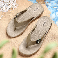 Front upper side image of A close up slight high angle shot of single color men's flip flop sandal by flite. The sandal has a textured, slightly bumpy footbed and a thick durable looking sole. The thong strap is wide an also textured with horizontal ridges. 