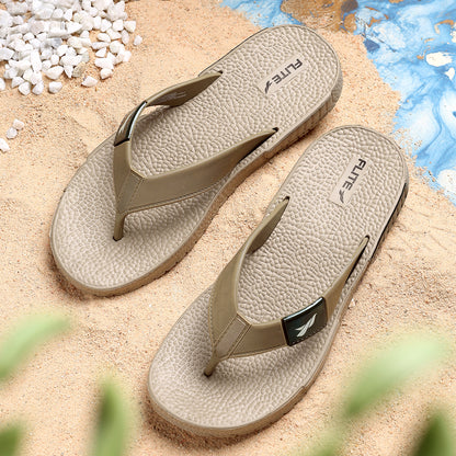Front upper side image of A close up slight high angle shot of single color men's flip flop sandal by flite. The sandal has a textured, slightly bumpy footbed and a thick durable looking sole. The thong strap is wide an also textured with horizontal ridges. 